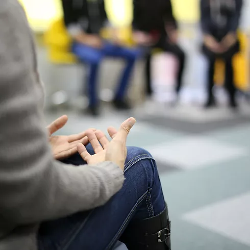 Person sitting with open palms